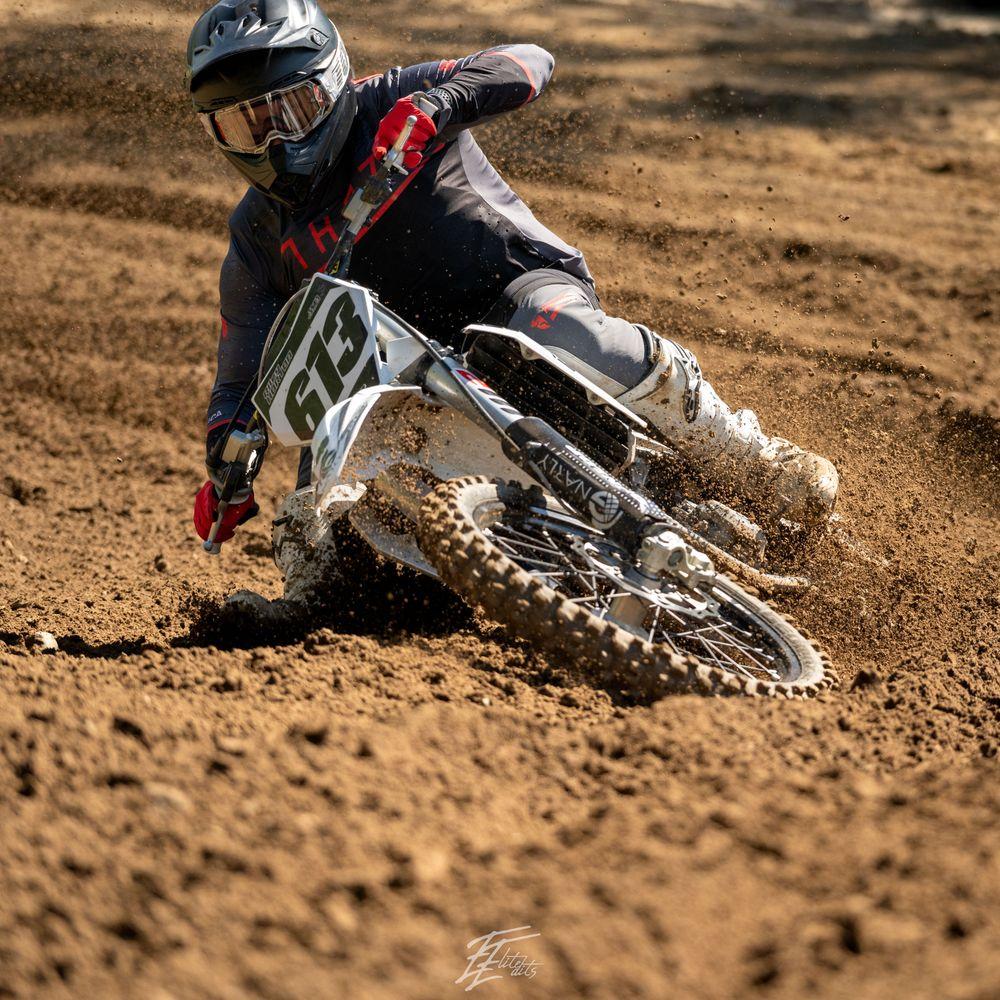 Rider whipping over a jump against the sky